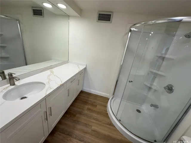 a bathroom with a double vanity sink and a mirror