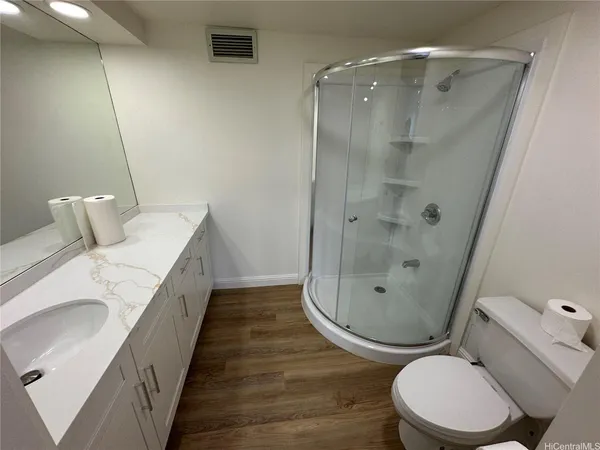 a bathroom with a toilet and a shower