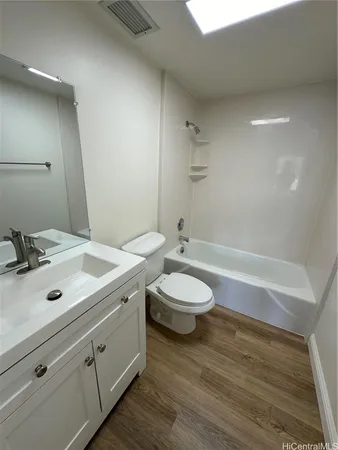 a bathroom with a double vanity sink toilet and shower