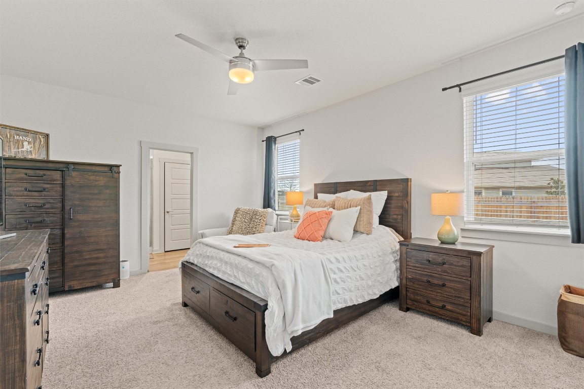 121 Tequilana Pass Leander, TX 78641 - Photo 13 of 39 a bedroom with a bed and a fireplace