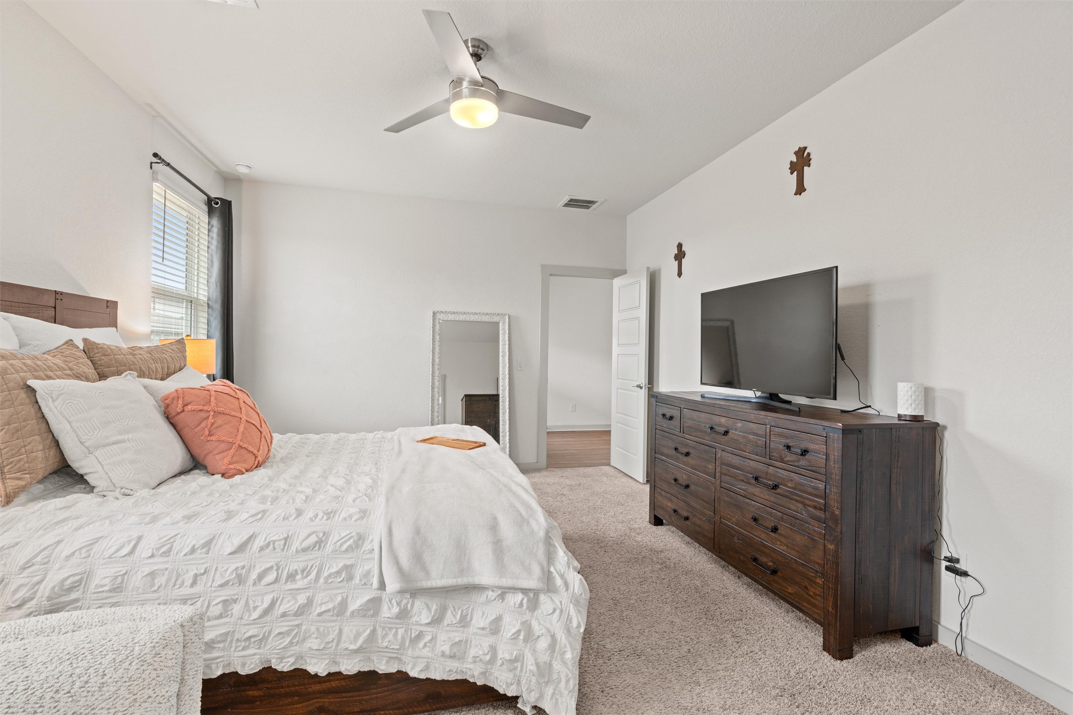 121 Tequilana Pass Leander, TX 78641 - Photo 14 of 39 a bedroom with a bed and a flat screen tv