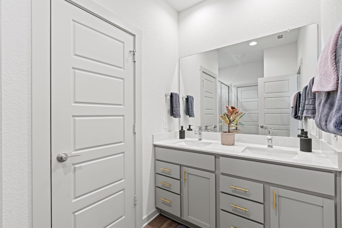 121 Tequilana Pass Leander, TX 78641 - Photo 15 of 39 a bathroom with a double vanity sink and mirror