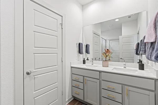 a bathroom with a double vanity sink and mirror