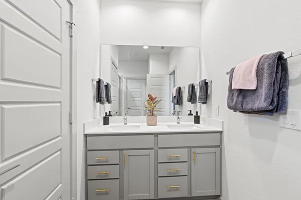 a bathroom with a sink vanity and mirror