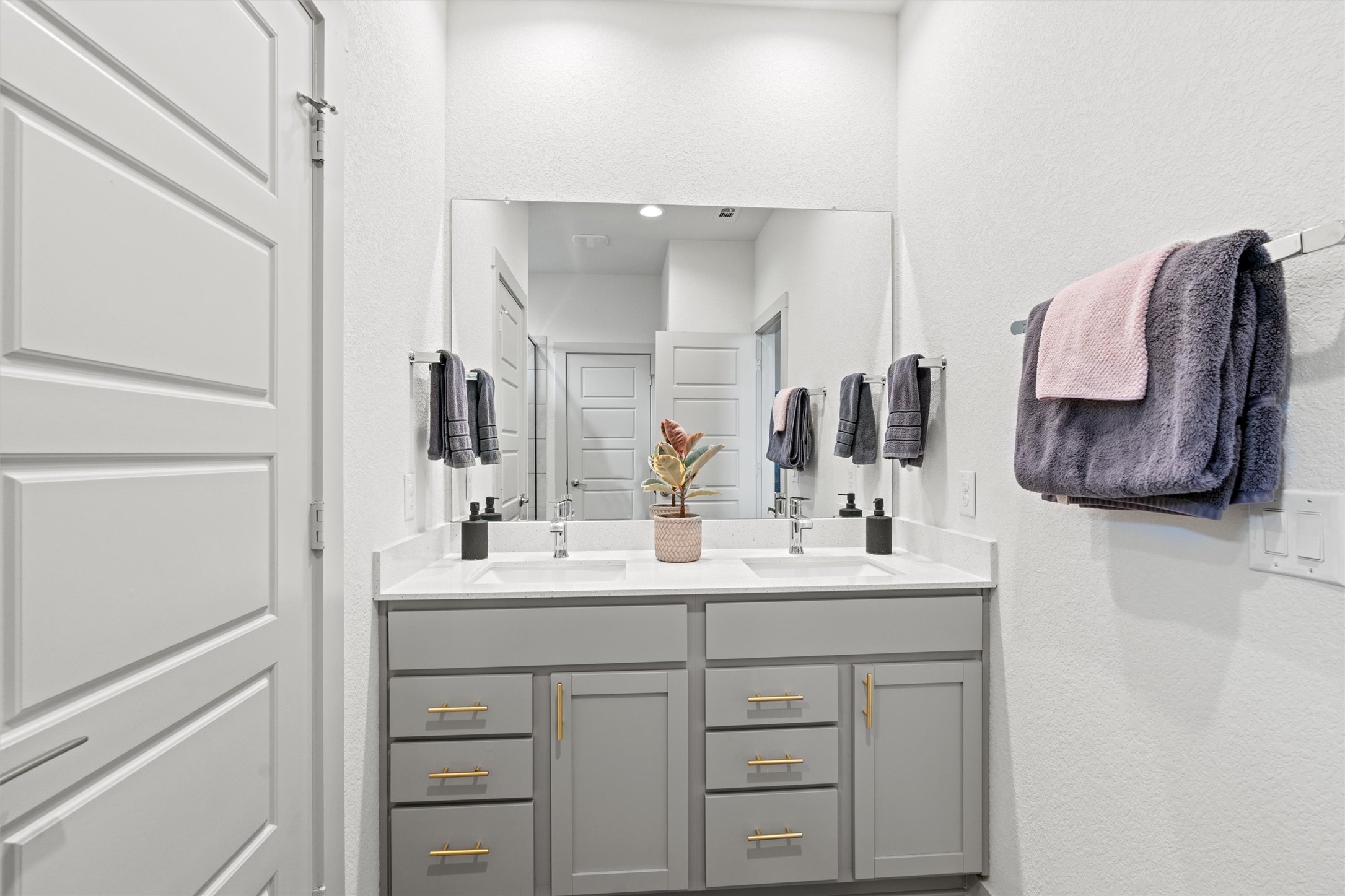 121 Tequilana Pass Leander, TX 78641 - Photo 16 of 39 a bathroom with a sink vanity and mirror
