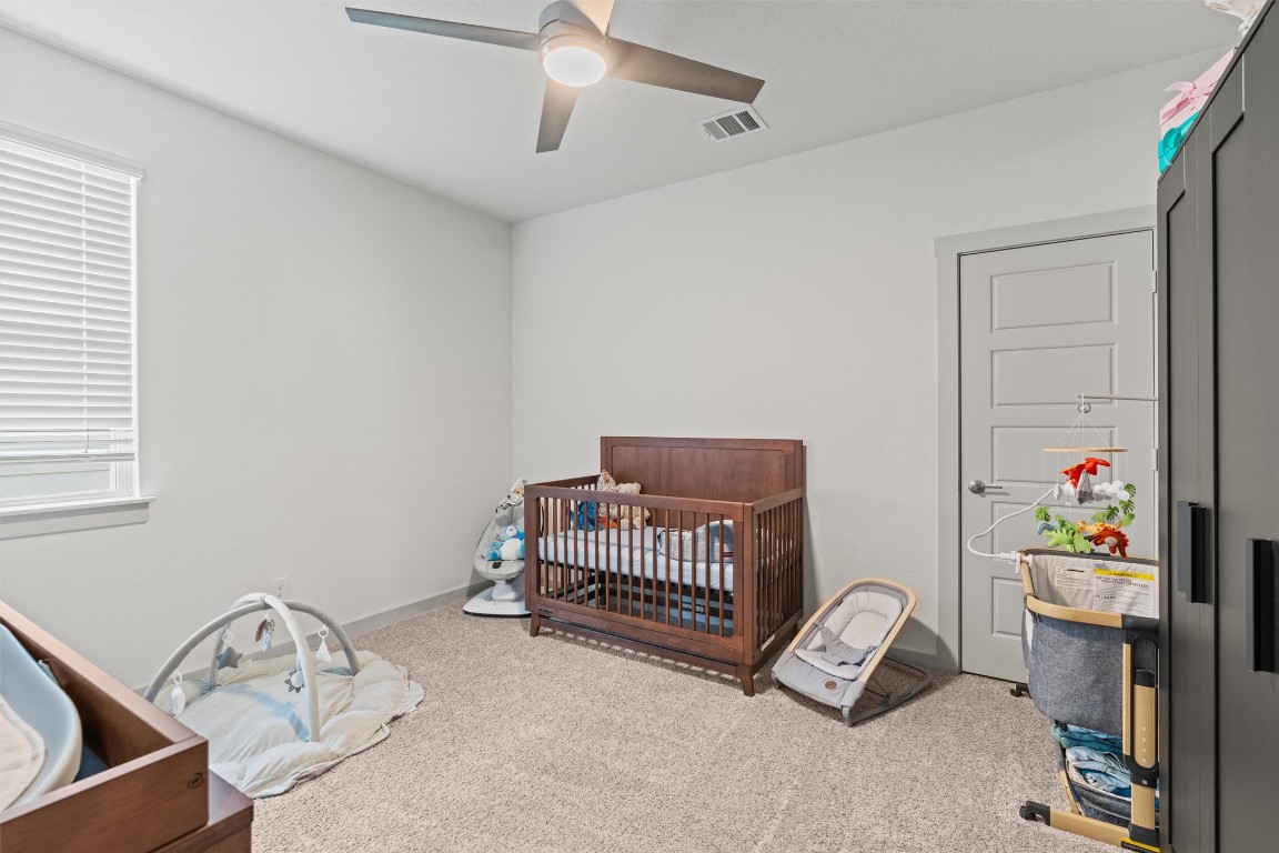 121 Tequilana Pass Leander, TX 78641 - Photo 20 of 39 a bedroom with a bed and a window