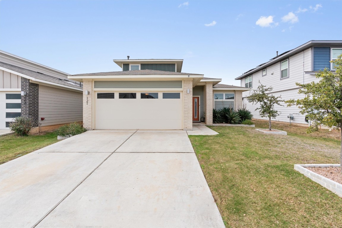 121 Tequilana Pass Leander, TX 78641 - Photo 2 of 39 a view of a white house with a yard