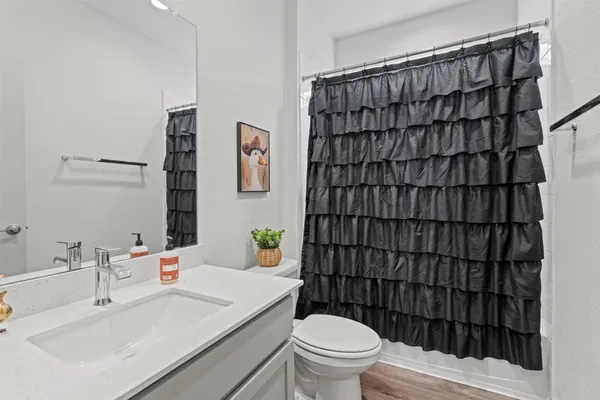 a bathroom with a sink toilet and shower