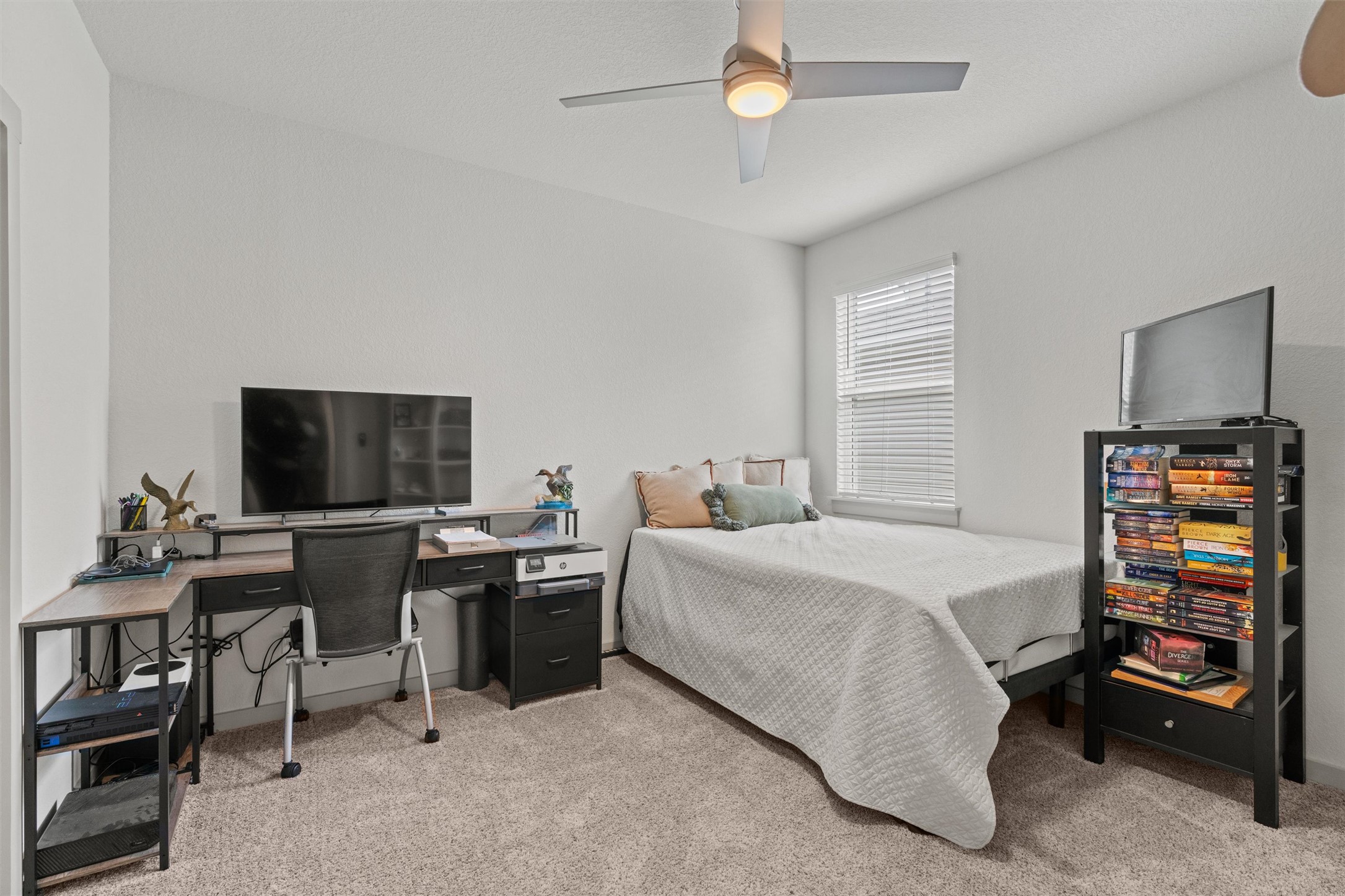 121 Tequilana Pass Leander, TX 78641 - Photo 24 of 39 a bedroom with a bed and a flat screen tv