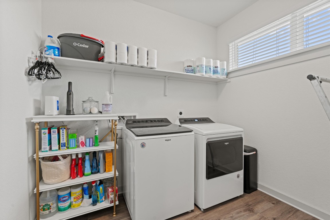 121 Tequilana Pass Leander, TX 78641 - Photo 26 of 39 Laundry room with washer and dryer and dark wood finished floors