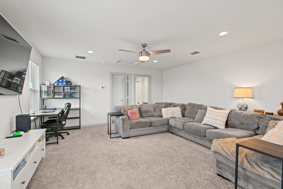 121 Tequilana Pass Leander, TX 78641 - Photo 27 of 39 a living room with furniture and a flat screen tv
