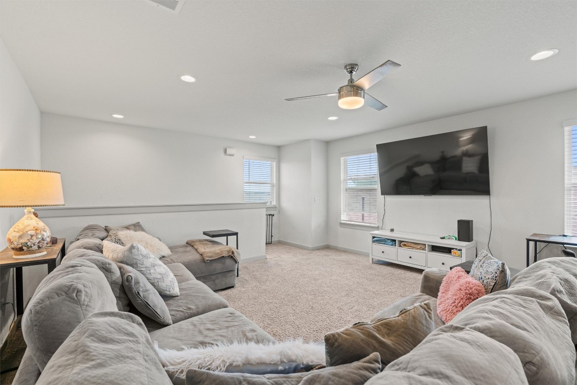 121 Tequilana Pass Leander, TX 78641 - Photo 28 of 39 a living room with furniture and a flat screen tv