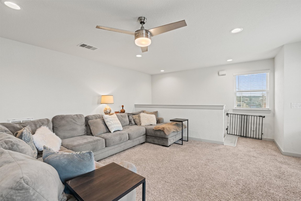 121 Tequilana Pass Leander, TX 78641 - Photo 29 of 39 Carpeted living area featuring recessed lighting and ceiling fan