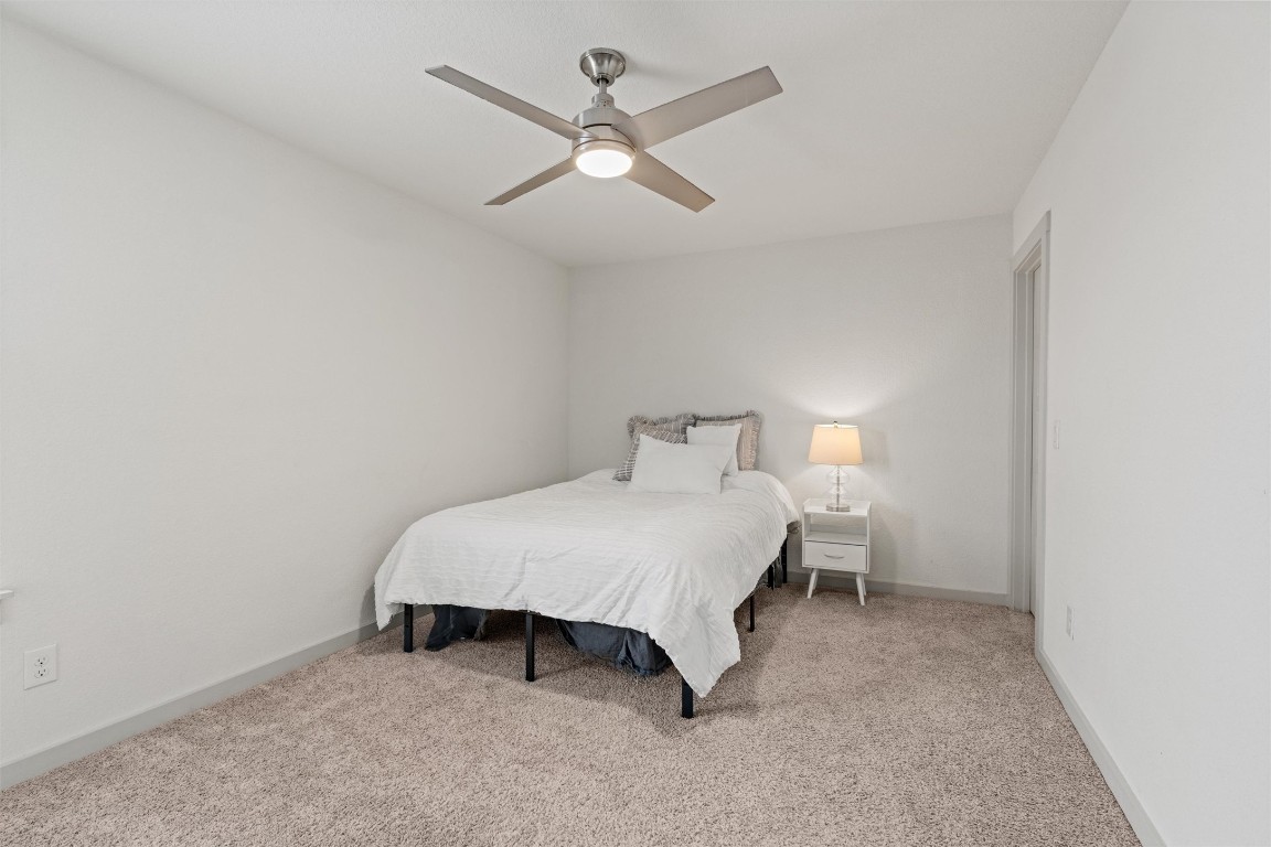 121 Tequilana Pass Leander, TX 78641 - Photo 30 of 39 a bedroom with a bed and ceiling fan