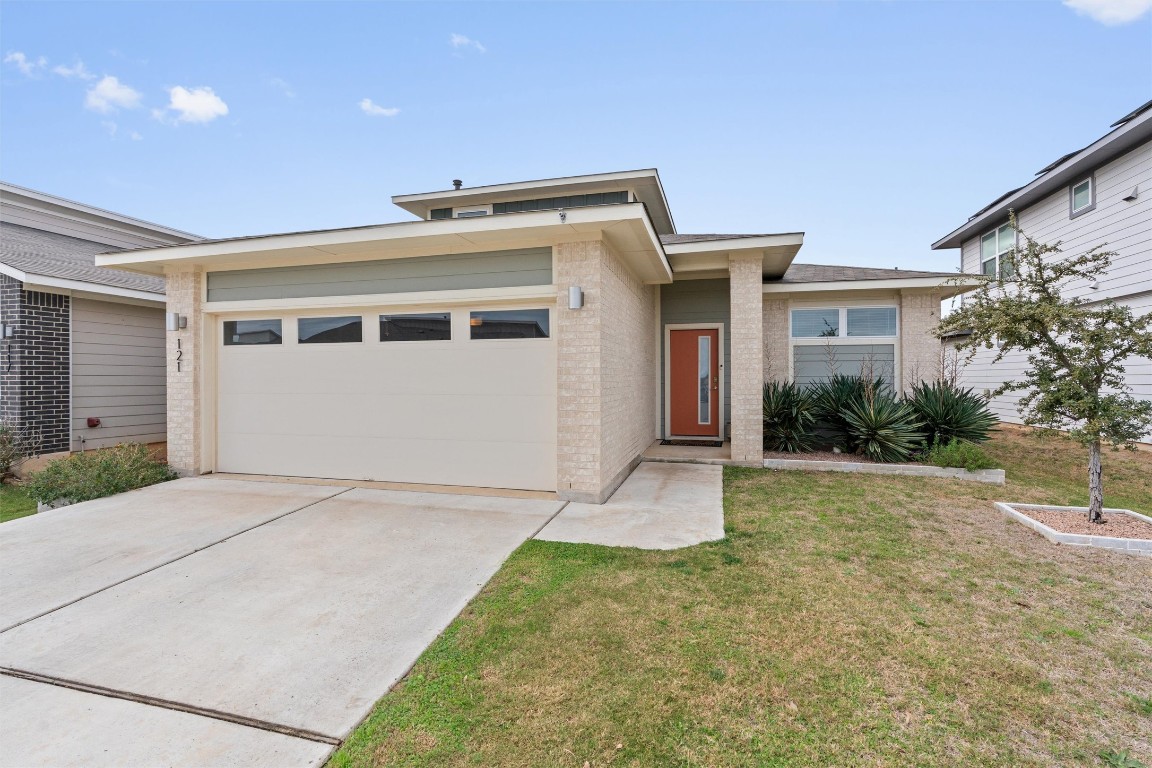 121 Tequilana Pass Leander, TX 78641 - Photo 3 of 39 Prairie-style home with brick siding, a front yard, concrete driveway, and a garage