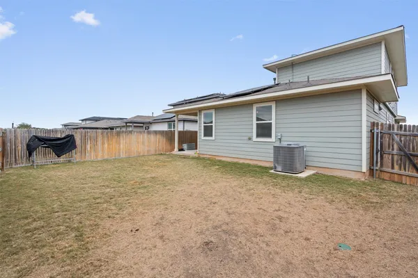 a view of a house with a wooden fence