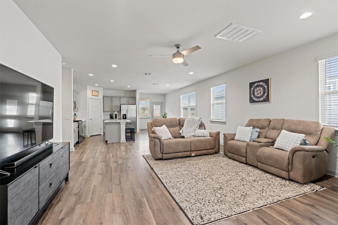 121 Tequilana Pass Leander, TX 78641 - Photo 5 of 39 a living room with furniture and a wooden floor