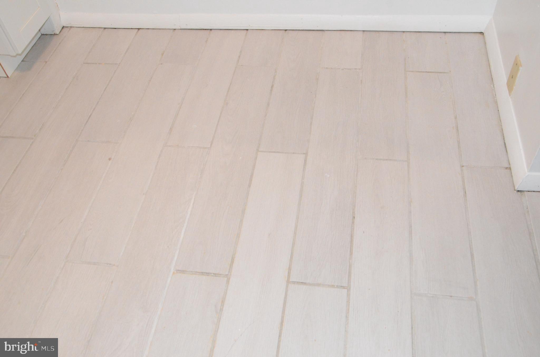 521 Epsom Road, Unit 2D Towson, MD 21286 - Photo 14 of 28 Plank tile floors in the kitchen
