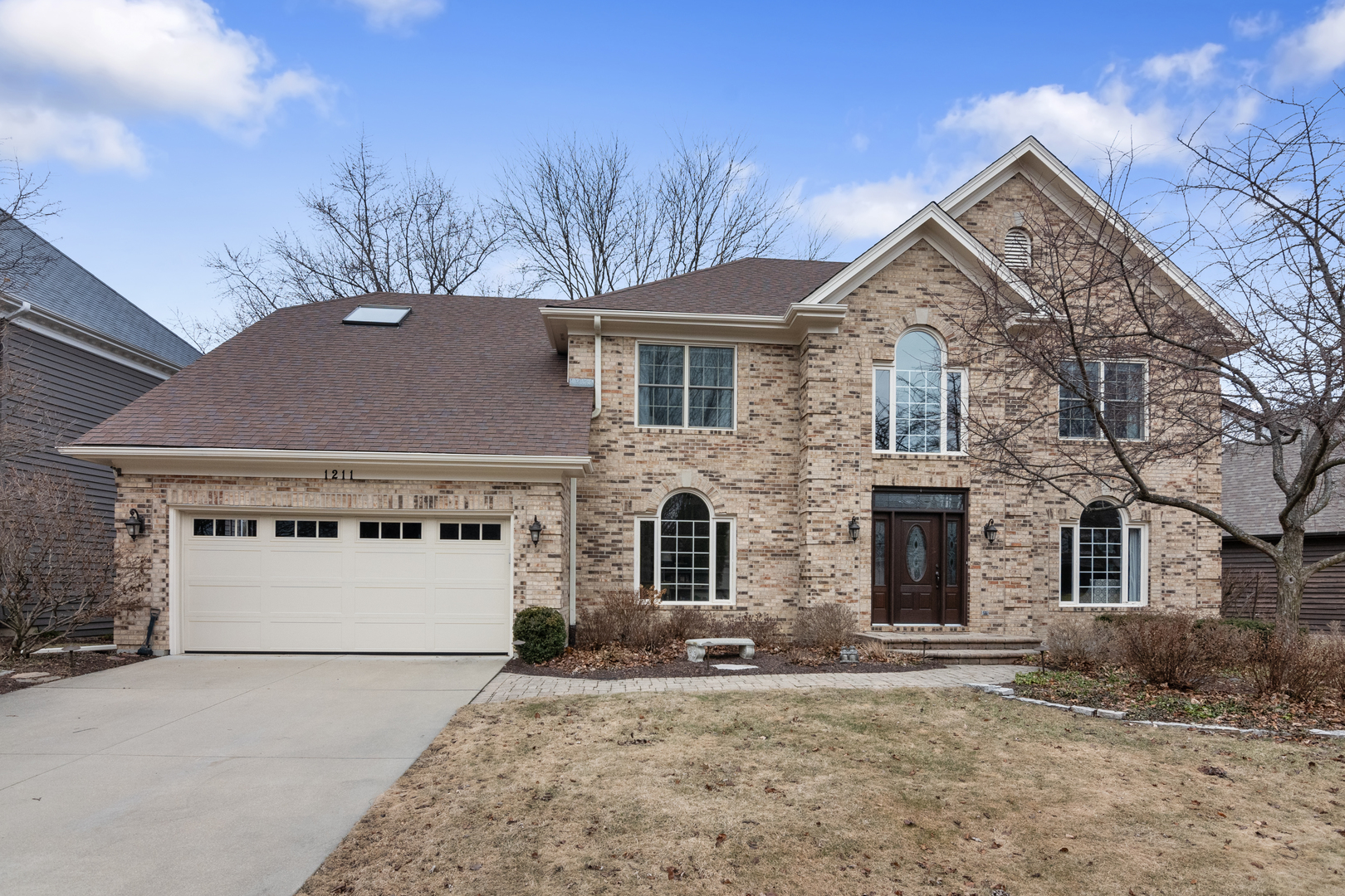 1211 Midwest Lane Wheaton, IL 60189 - Photo 1 of 1 a front view of a house with a yard and garage