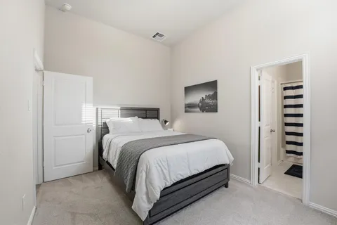 a bedroom with a bed and cabinets