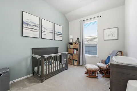 a bedroom with furniture and a window