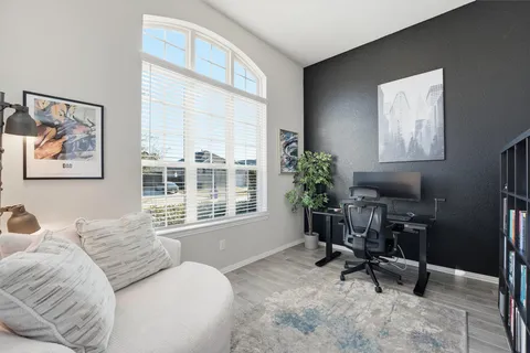 a bedroom with furniture and a window