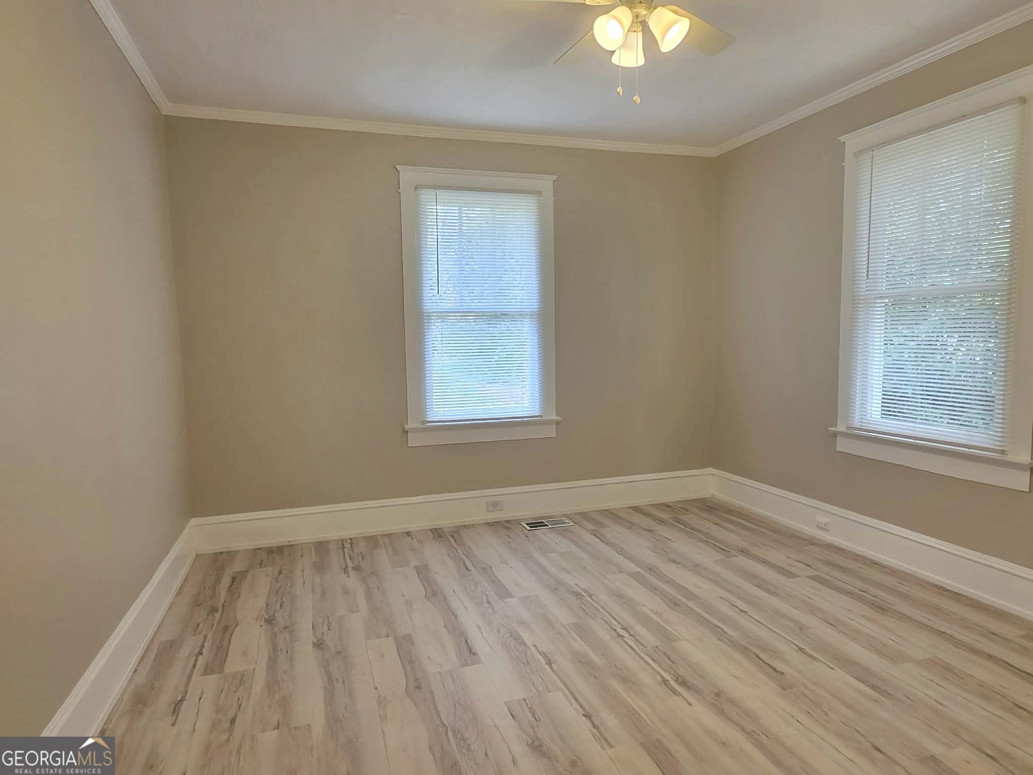404 West Gordon Street Thomaston, GA 30286 - Photo 17 of 26 wooden floor in an empty room with a window