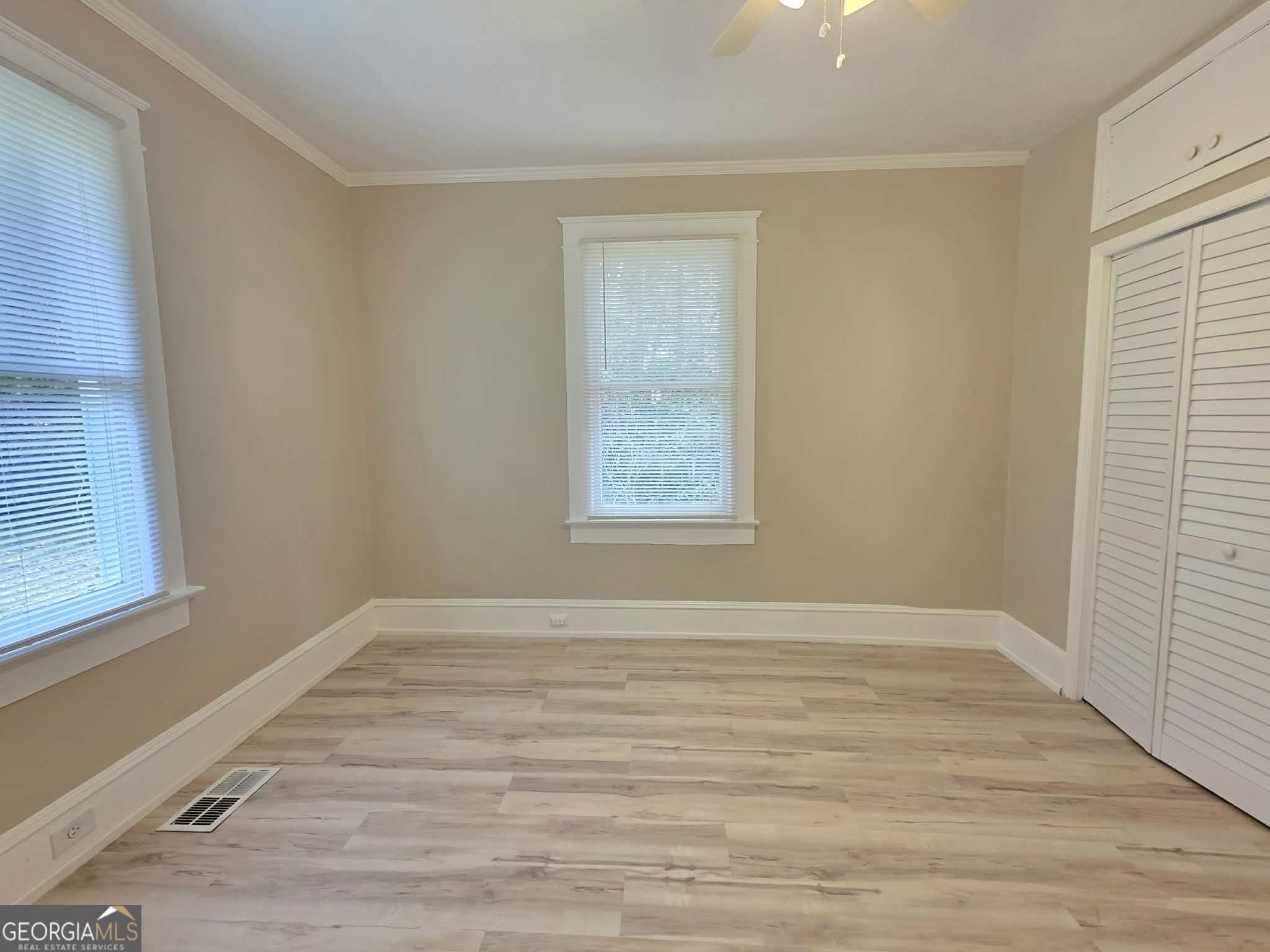 404 West Gordon Street Thomaston, GA 30286 - Photo 18 of 26 a view of an empty room with wooden floor and a window