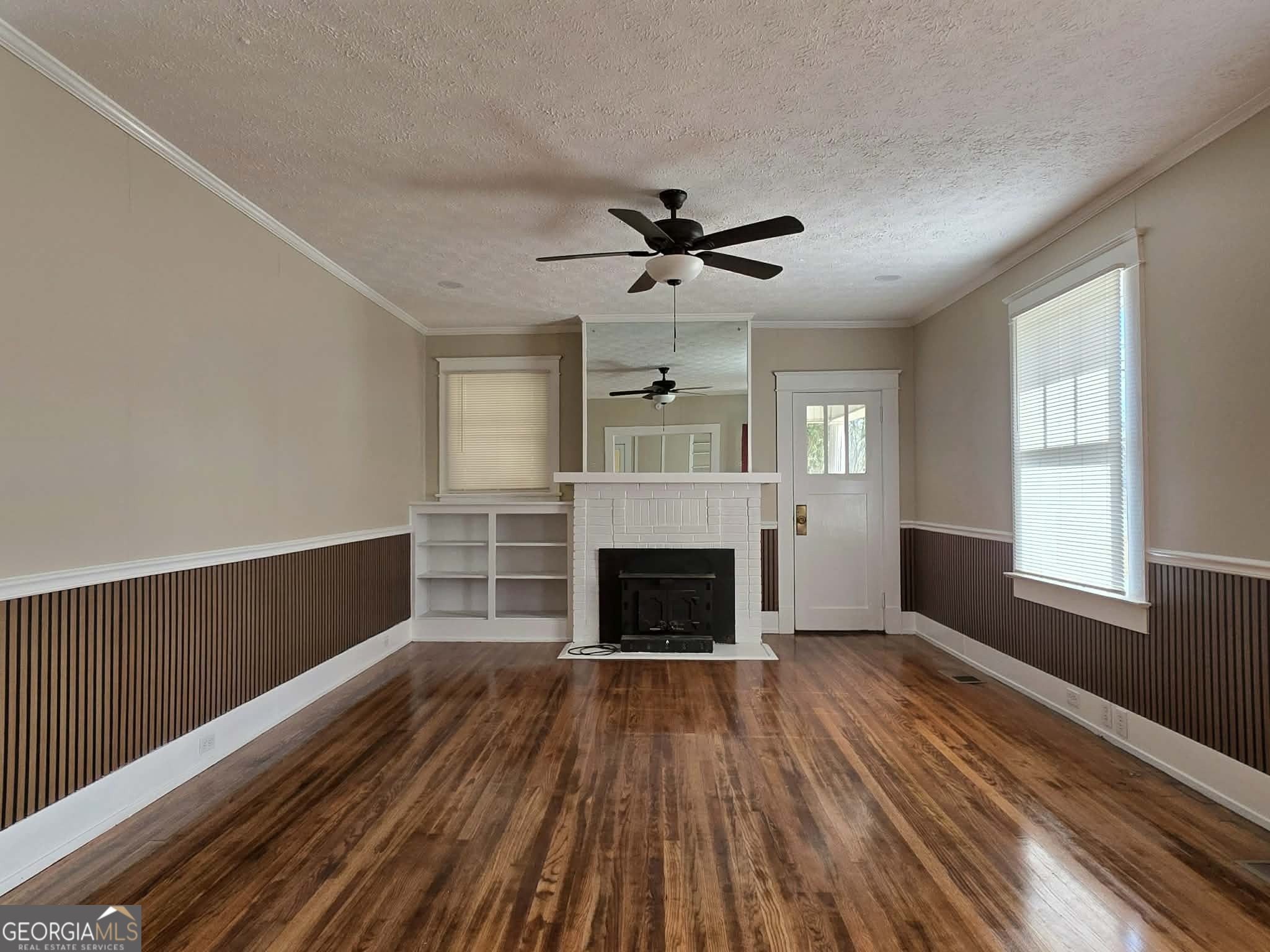 404 West Gordon Street Thomaston, GA 30286 - Photo 4 of 26 wooden floor fireplace and windows in an empty room