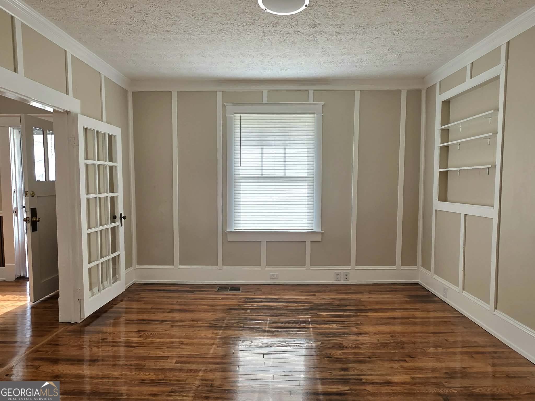 404 West Gordon Street Thomaston, GA 30286 - Photo 8 of 26 a view of an empty room with wooden floor and a window
