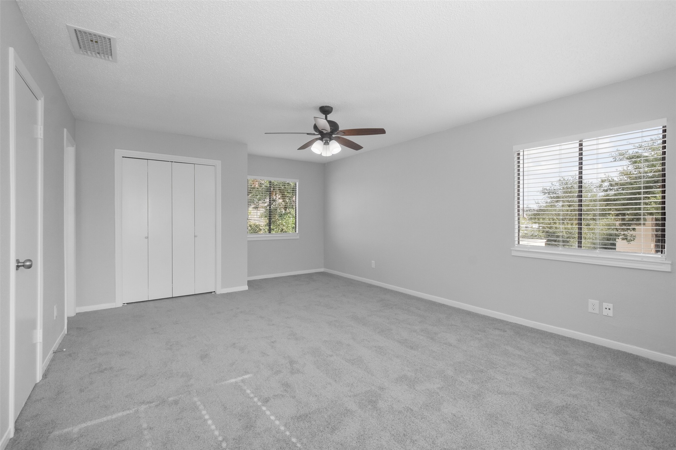 402 Tuam Street, Unit 2 Houston, TX 77006 - Photo 20 of 39 Located on the second floor, this is the primary bedroom suite, which is very spacious with carpet, ceiling fan, and two closets!