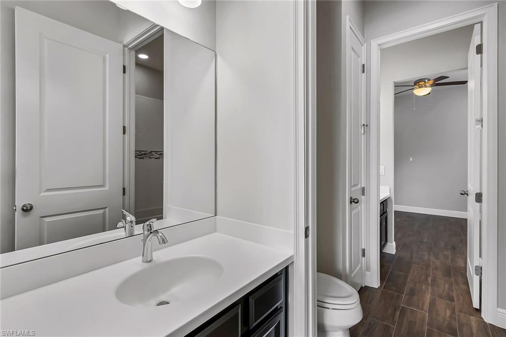 3668 Pilot Circle Naples, FL 34120 - Photo 14 of 29 a bathroom with a sink and a mirror