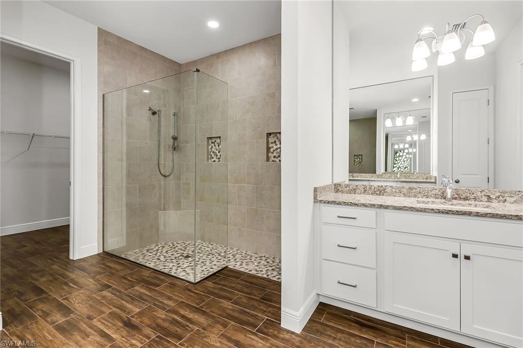 3668 Pilot Circle Naples, FL 34120 - Photo 19 of 29 a bathroom with a shower sink and mirror