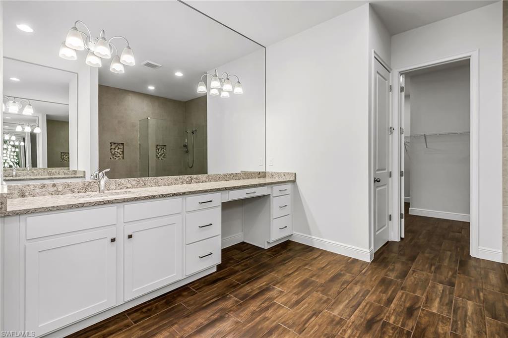 3668 Pilot Circle Naples, FL 34120 - Photo 20 of 29 a bathroom with a double vanity sink and mirror