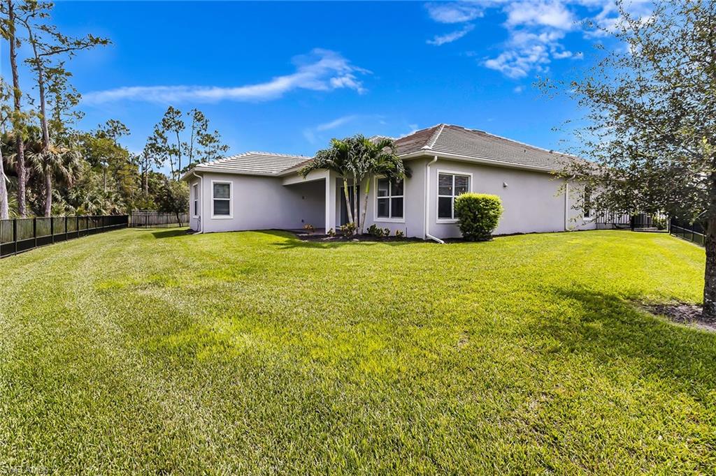 3668 Pilot Circle Naples, FL 34120 - Photo 22 of 29 a view of a house with a yard and garage