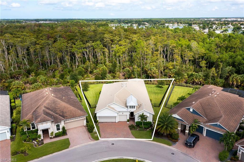 3668 Pilot Circle Naples, FL 34120 - Photo 24 of 29 a view of a swimming pool with a patio and garden