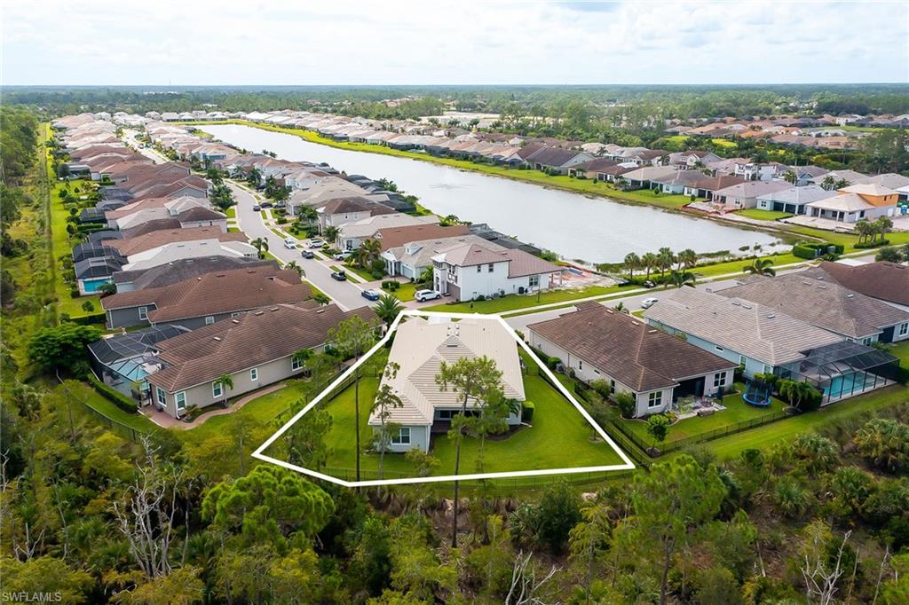 3668 Pilot Circle Naples, FL 34120 - Photo 25 of 29 an aerial view of residential houses with outdoor space and ocean view
