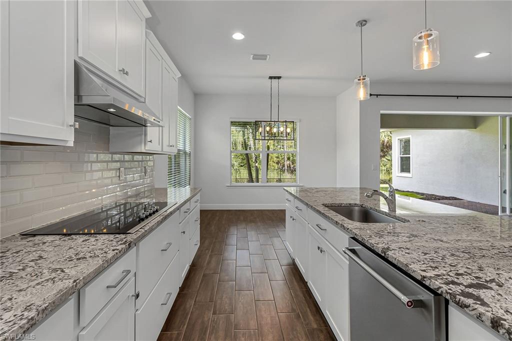 3668 Pilot Circle Naples, FL 34120 - Photo 6 of 29 a kitchen with granite countertop kitchen island a large counter space appliances and a sink