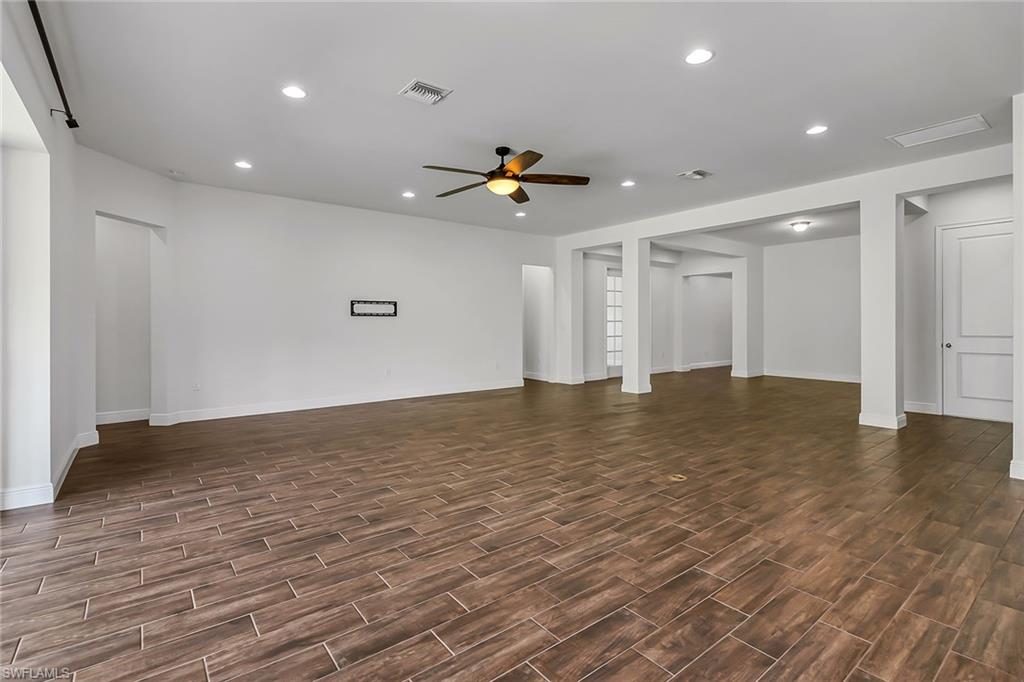 3668 Pilot Circle Naples, FL 34120 - Photo 8 of 29 a view of empty room with wooden floor and fan