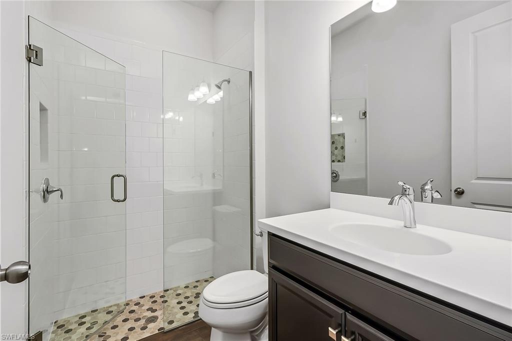 3668 Pilot Circle Naples, FL 34120 - Photo 10 of 29 a bathroom with a sink a toilet and shower