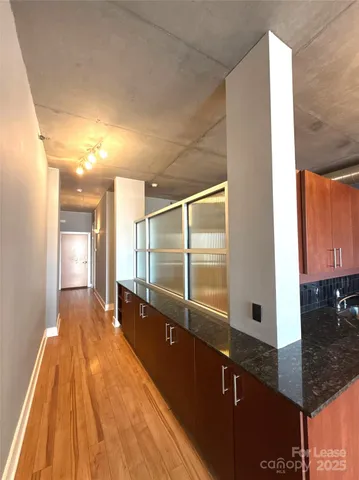 a spacious bathroom with a granite countertop sink a mirror and shower