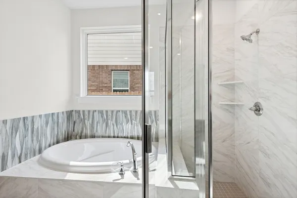 a bathroom with a white bath tub and shower