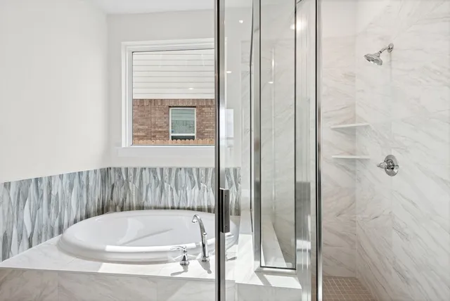 a bathroom with a white bath tub and shower