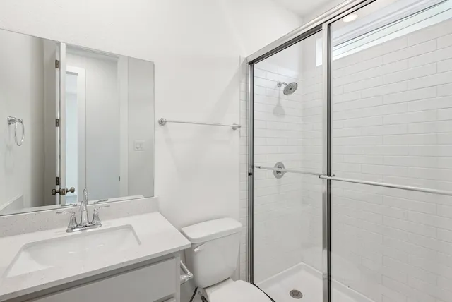 a bathroom with a sink toilet and shower