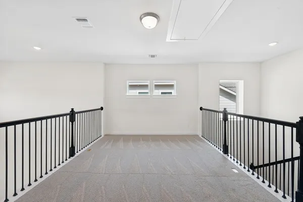 a view of a hallway with windows