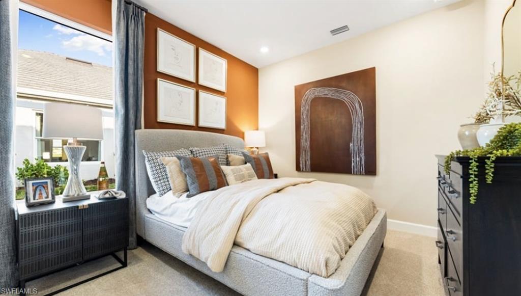 18073 Terracina Drive Fort Myers, FL 33913 - Photo 11 of 31 a bedroom with a large bed and a large window