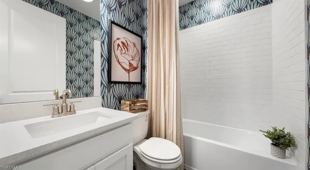 a spacious bedroom with a bed and a chandelier