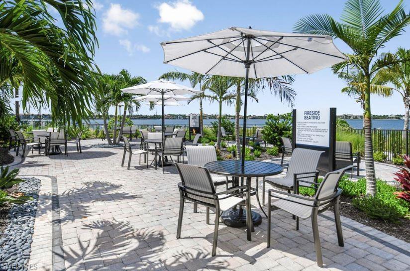 18073 Terracina Drive Fort Myers, FL 33913 - Photo 25 of 31 a view of a patio with a table and chairs under an umbrella