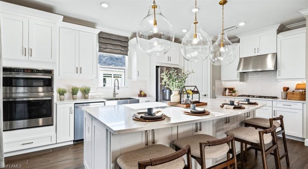 18073 Terracina Drive Fort Myers, FL 33913 - Photo 4 of 31 a kitchen with a dining table and chairs