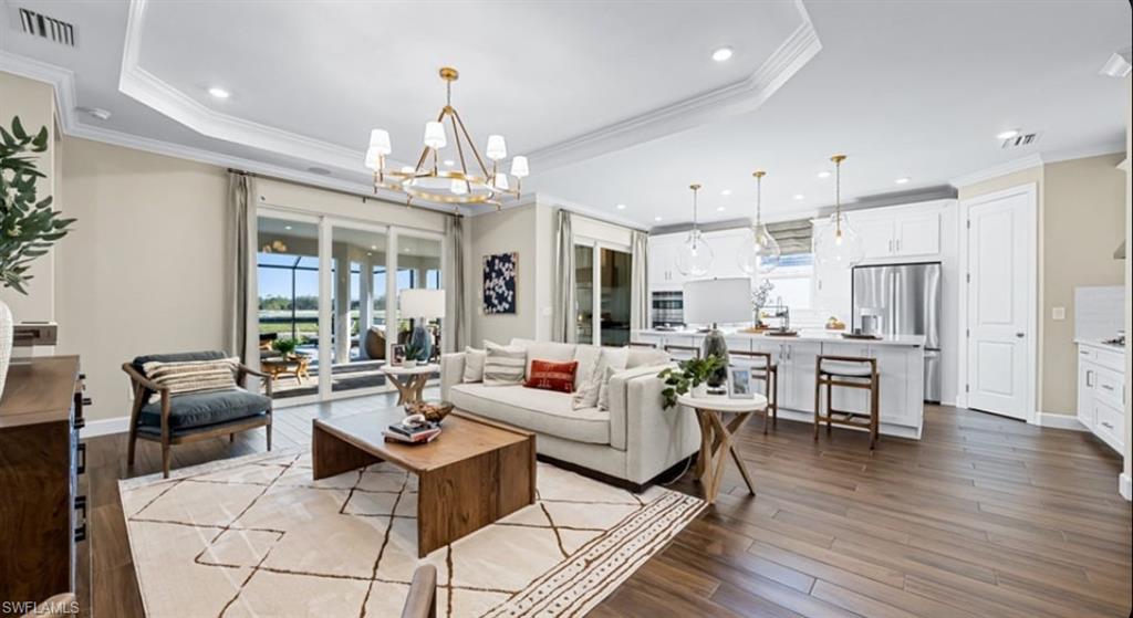 18073 Terracina Drive Fort Myers, FL 33913 - Photo 5 of 31 a living room with kitchen island furniture and a chandelier